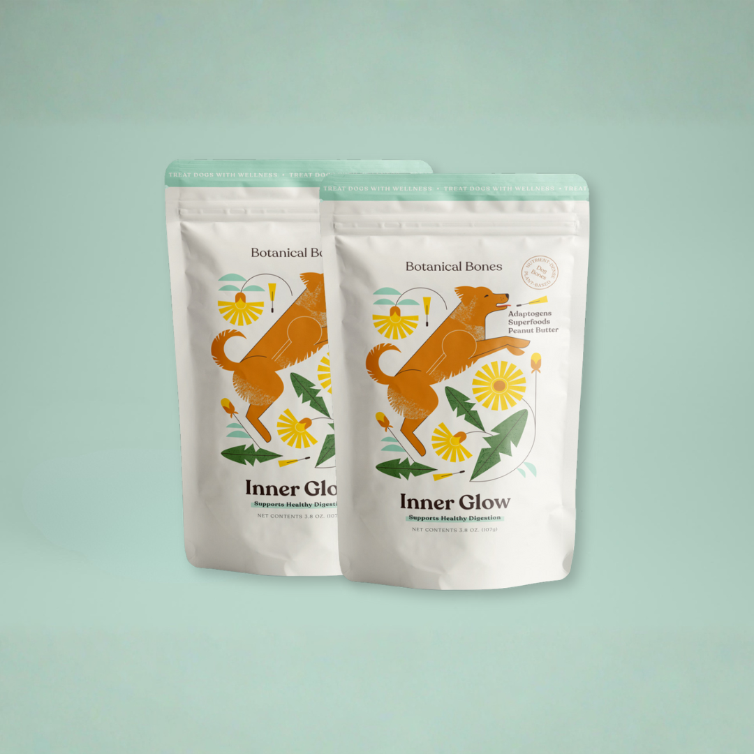 Two white packages labeled 'Inner Glow' with a dog illustration on a light green background